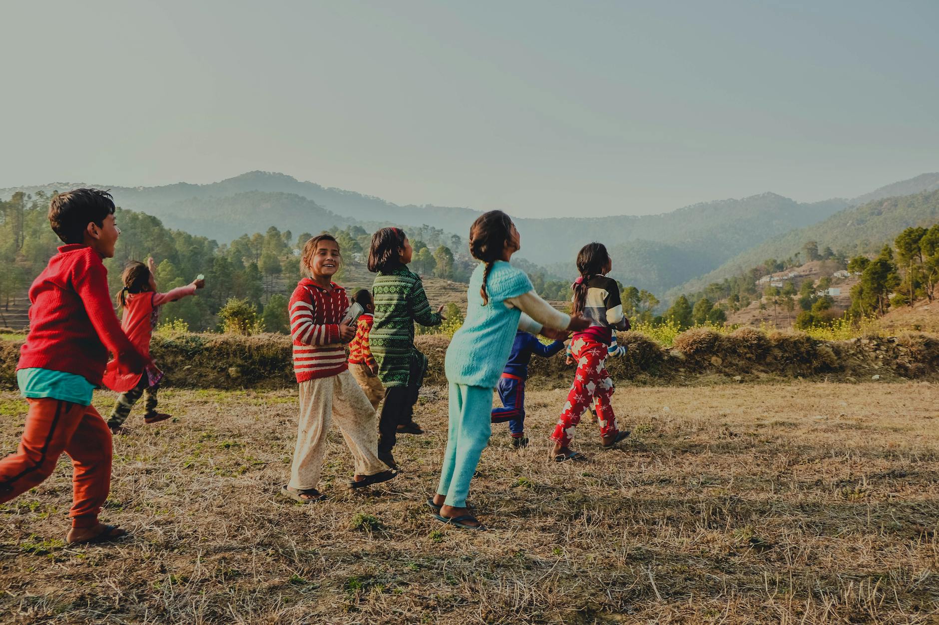 group of children running on a field