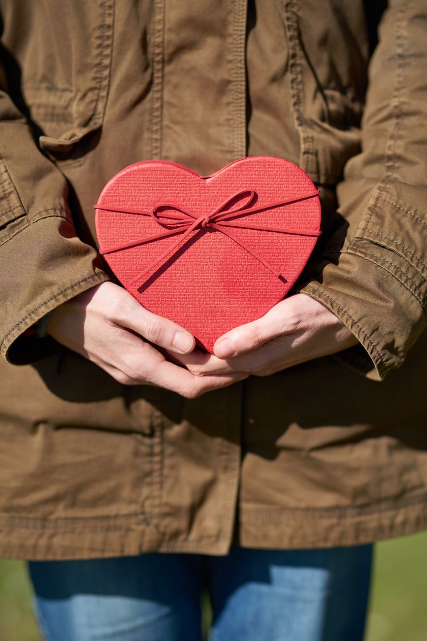 person holding heart shaped gift