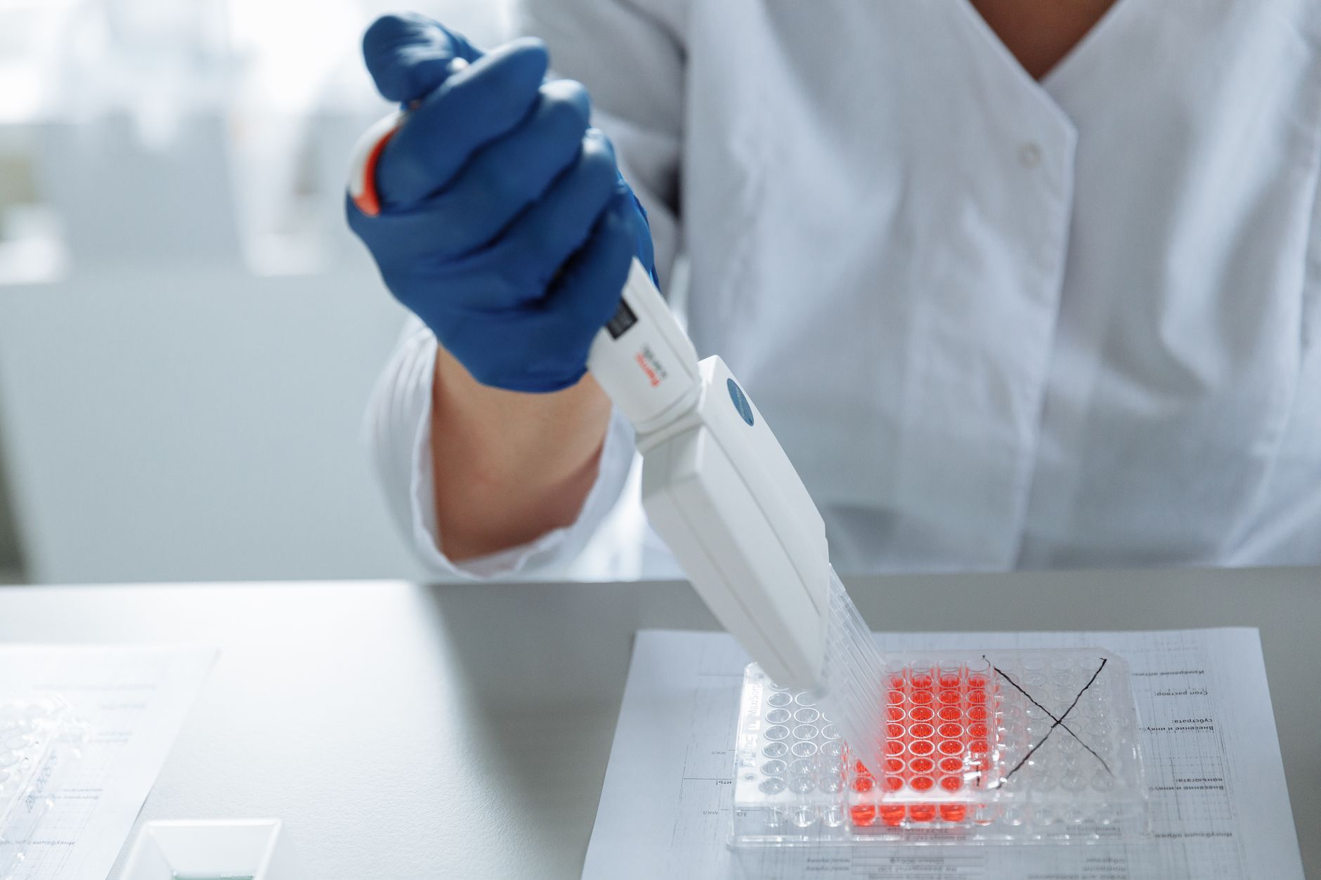 close up of a lab worker distributing medication into capsules